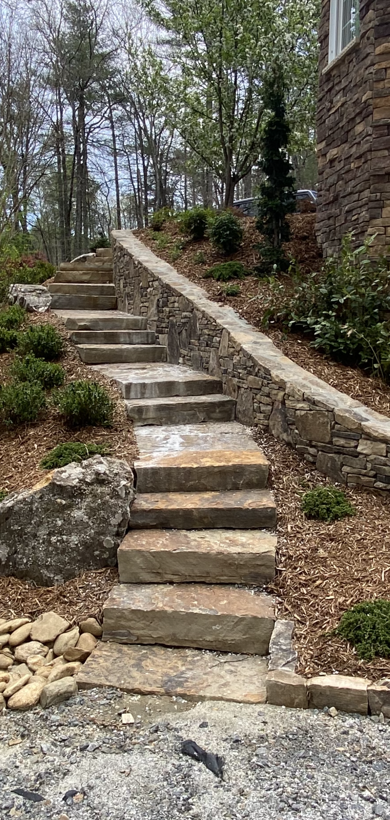 A set of stone stairs leading up to a house.