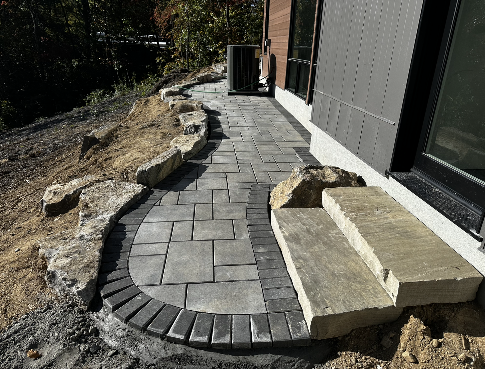 A stone walkway with steps leading to a house.