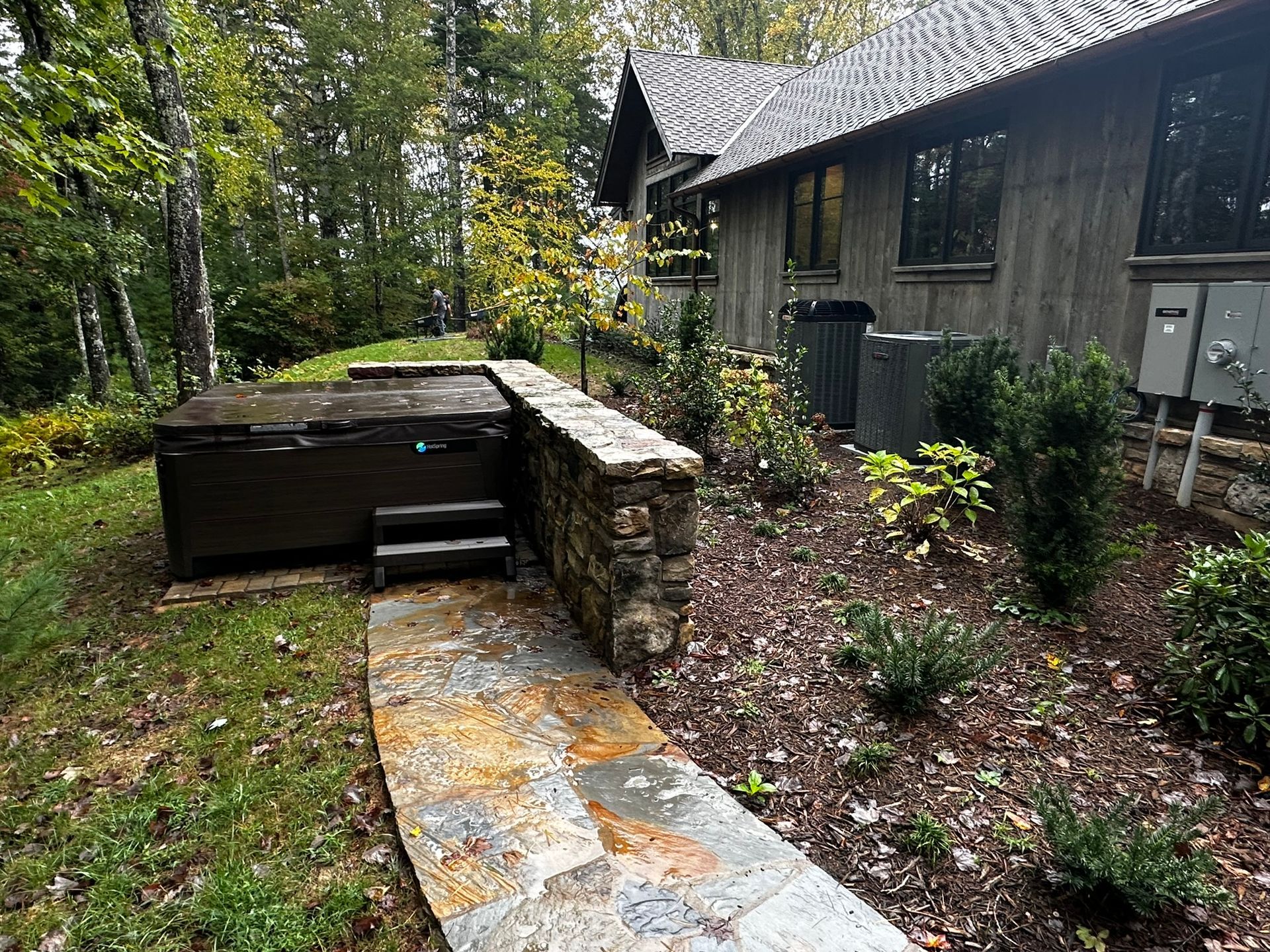 There is a hot tub in the backyard of a house.