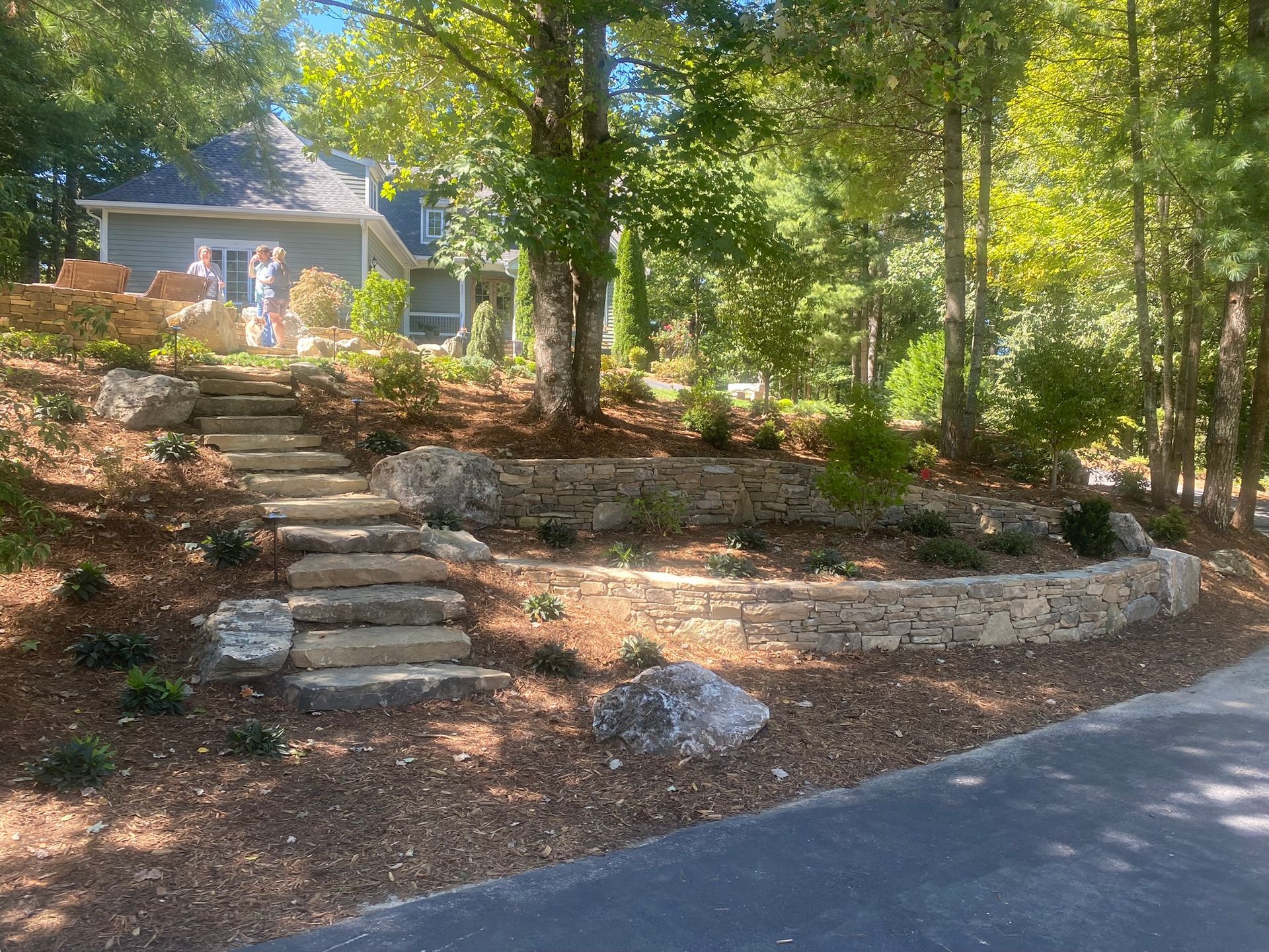There are stairs leading up to a house in the woods.