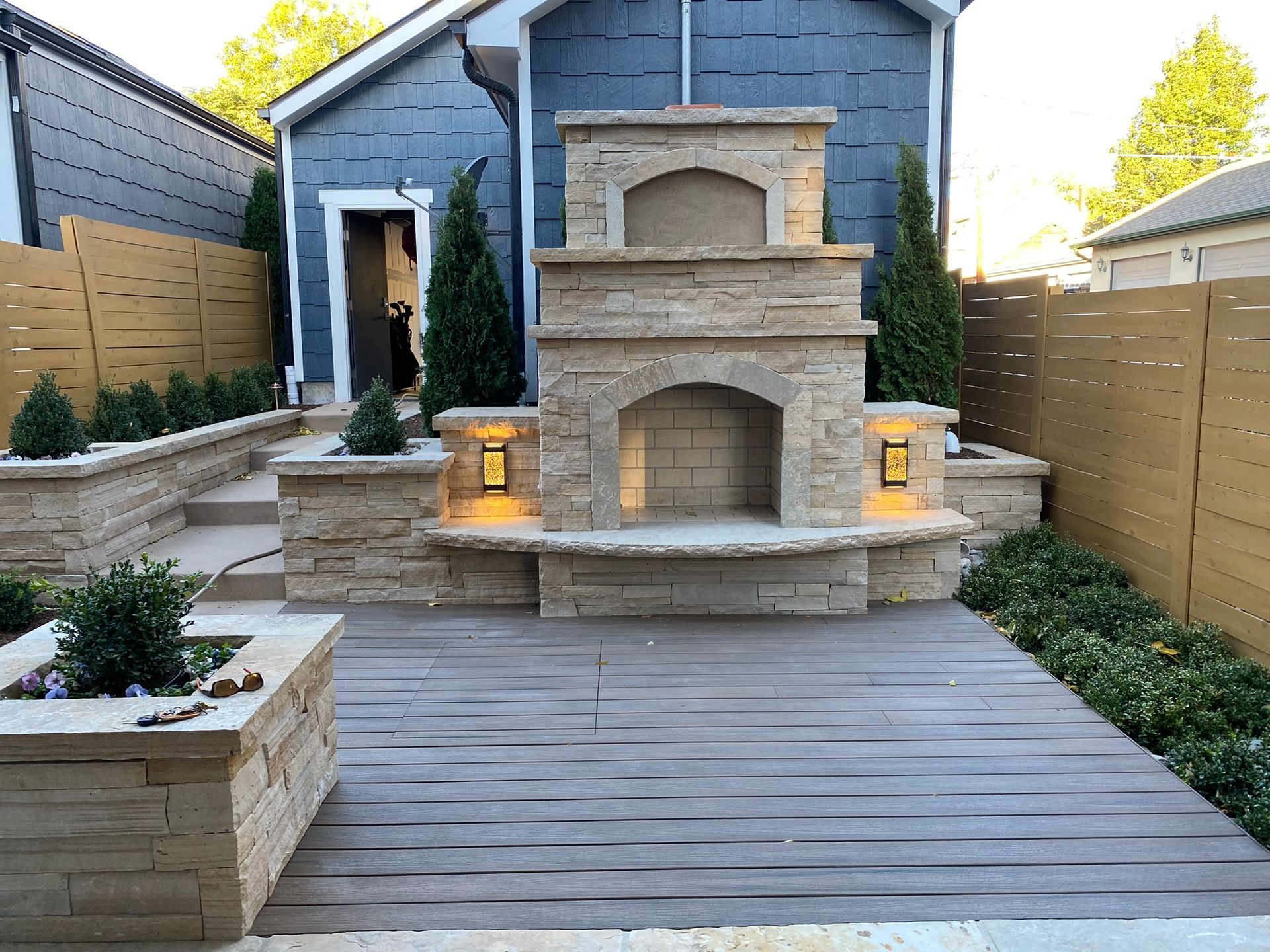 There is a fireplace in the backyard of a house.