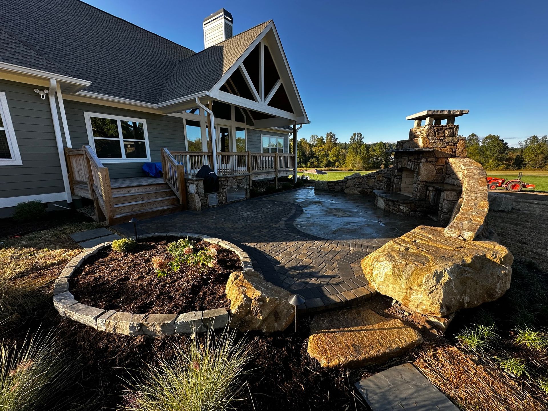 A large house with a fire pit in front of it.