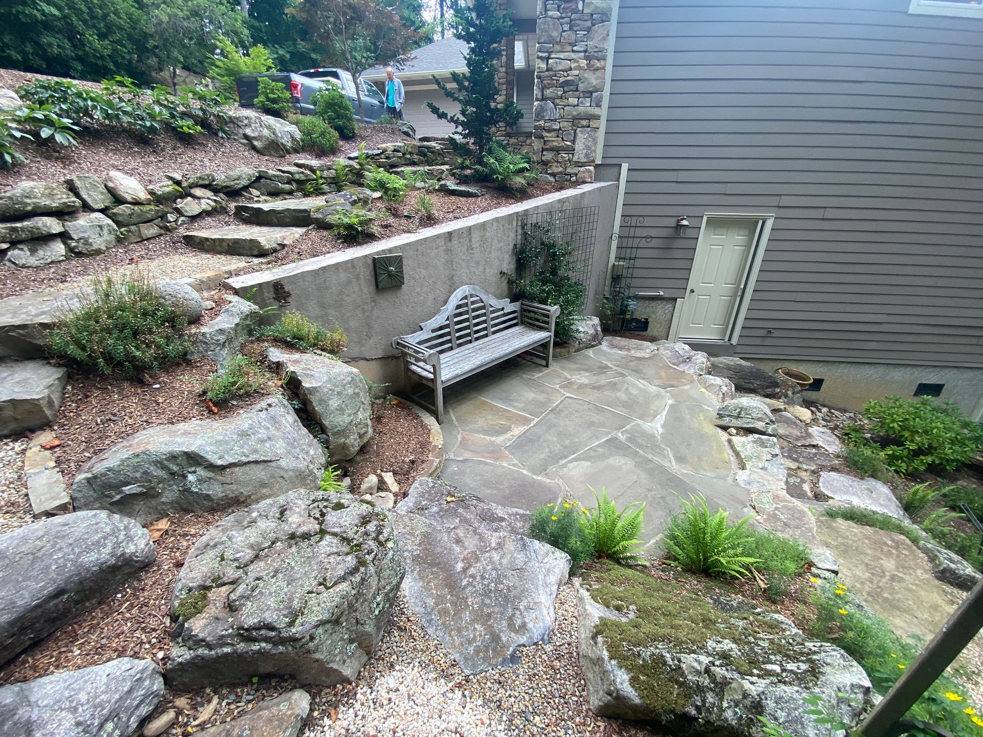 There is a bench in the middle of a rocky area.