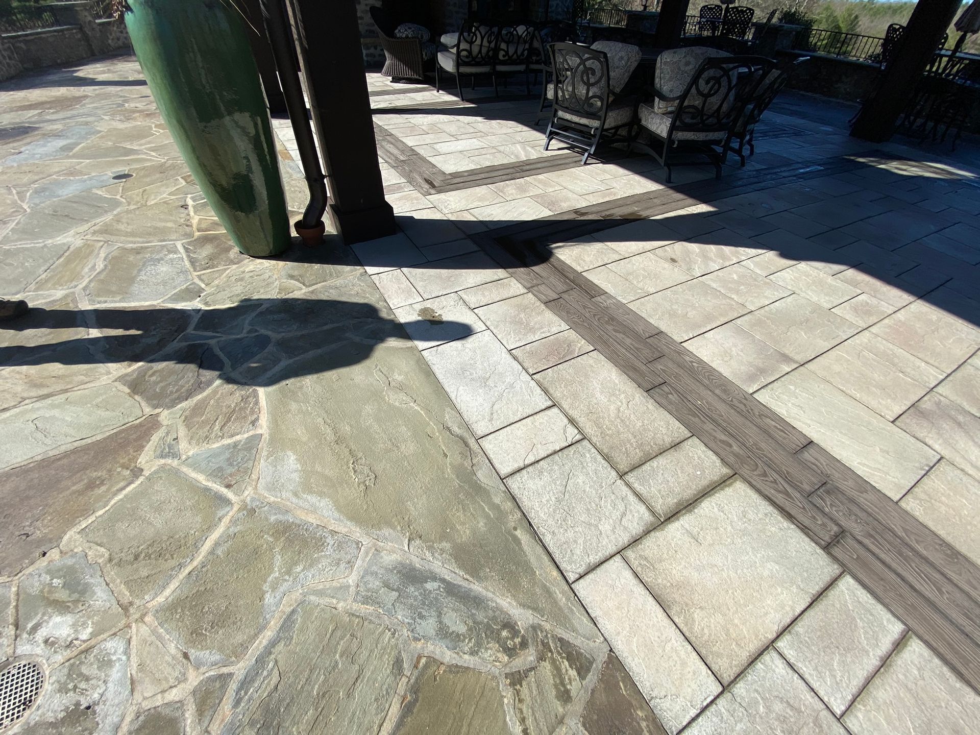 A patio with a table and chairs on it.