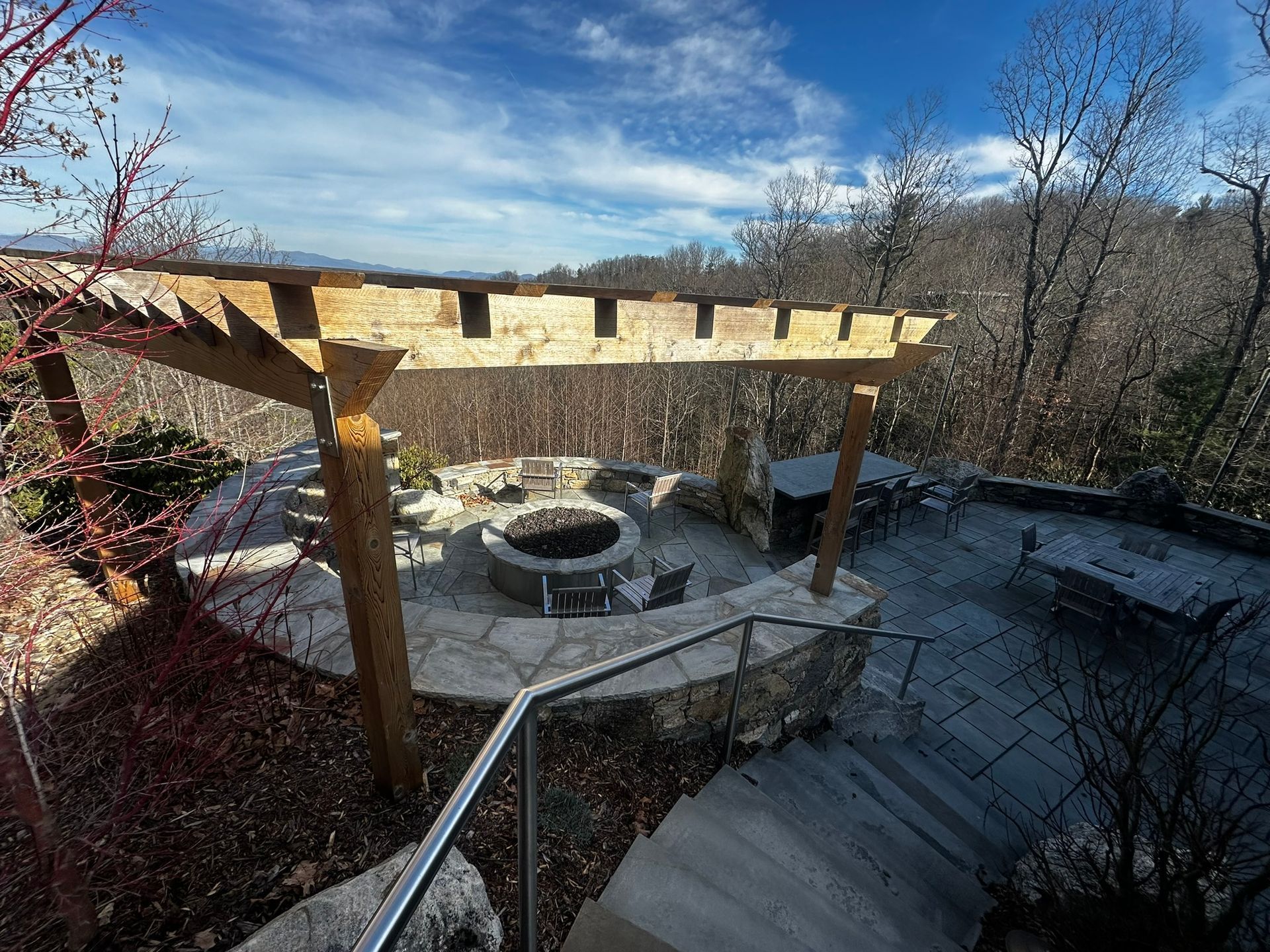 There is a fire pit in the middle of the patio.