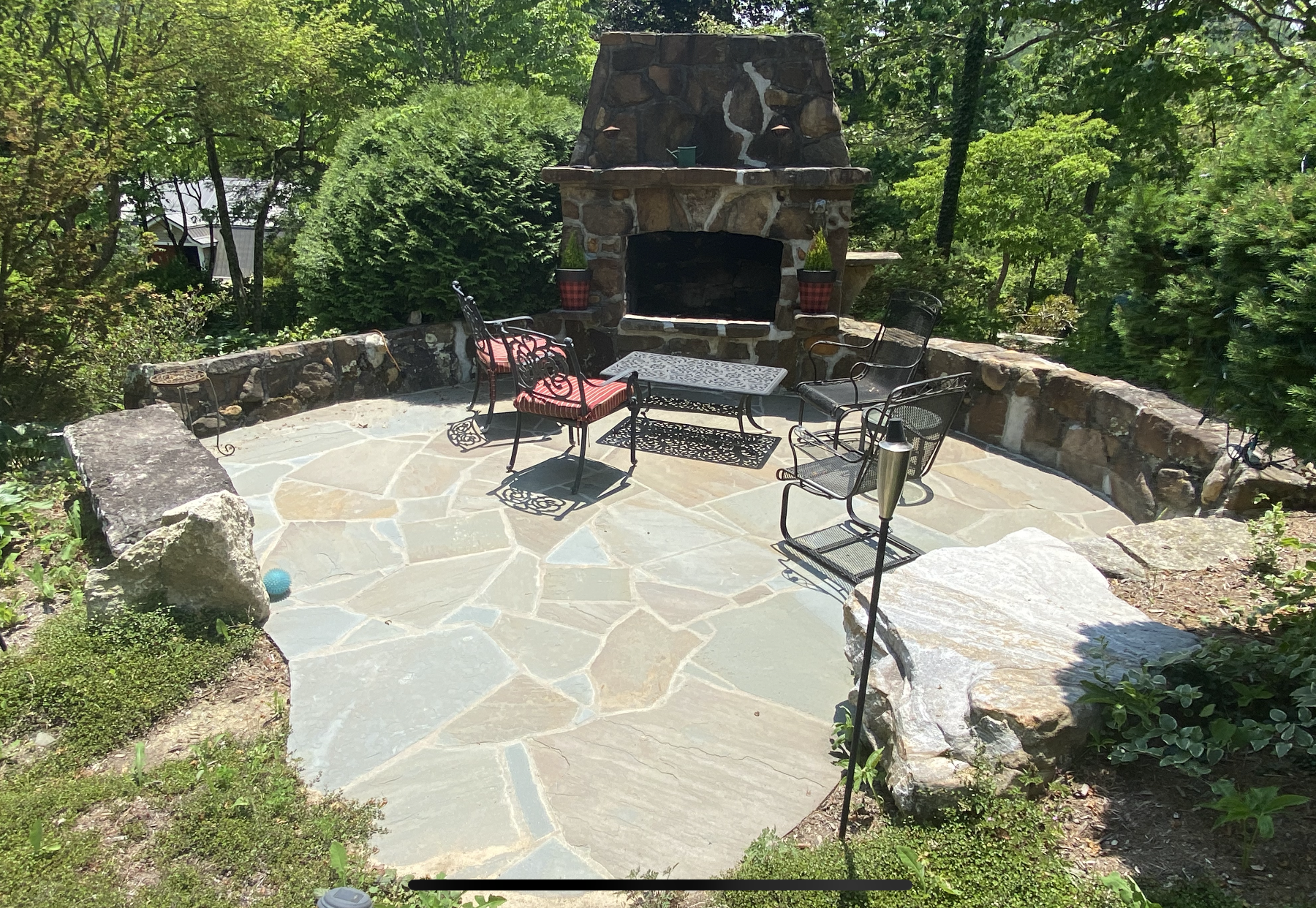 There is a fireplace in the middle of the patio.