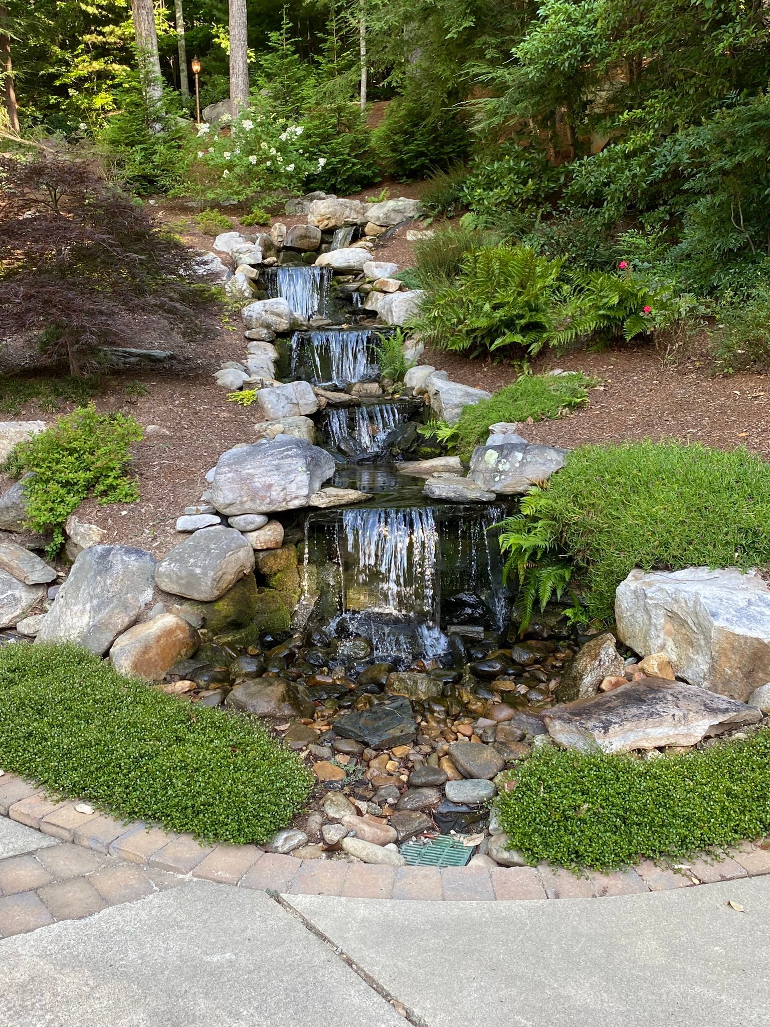 There is a waterfall in the middle of the garden.
