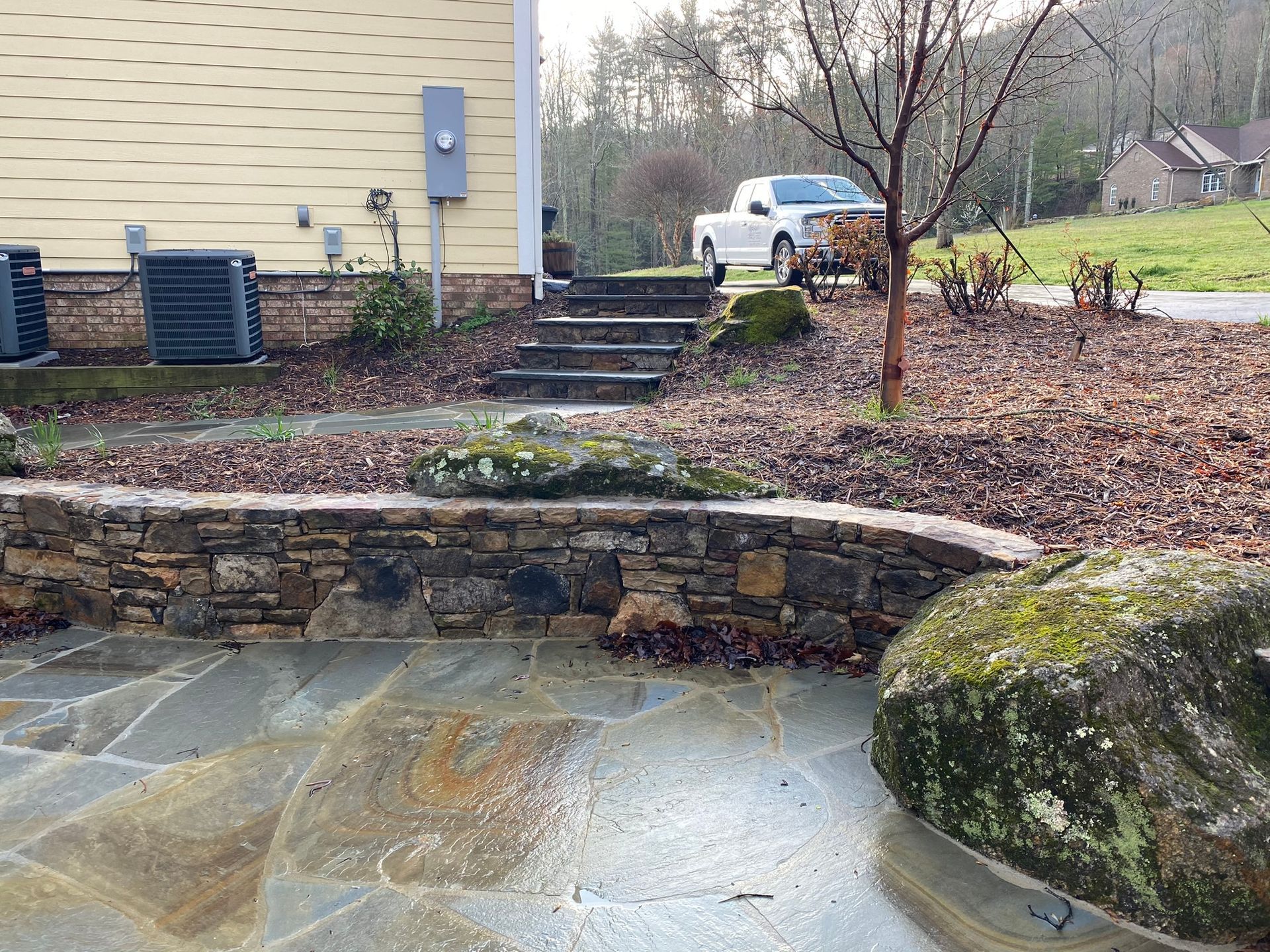 A white truck is parked in front of a house.
