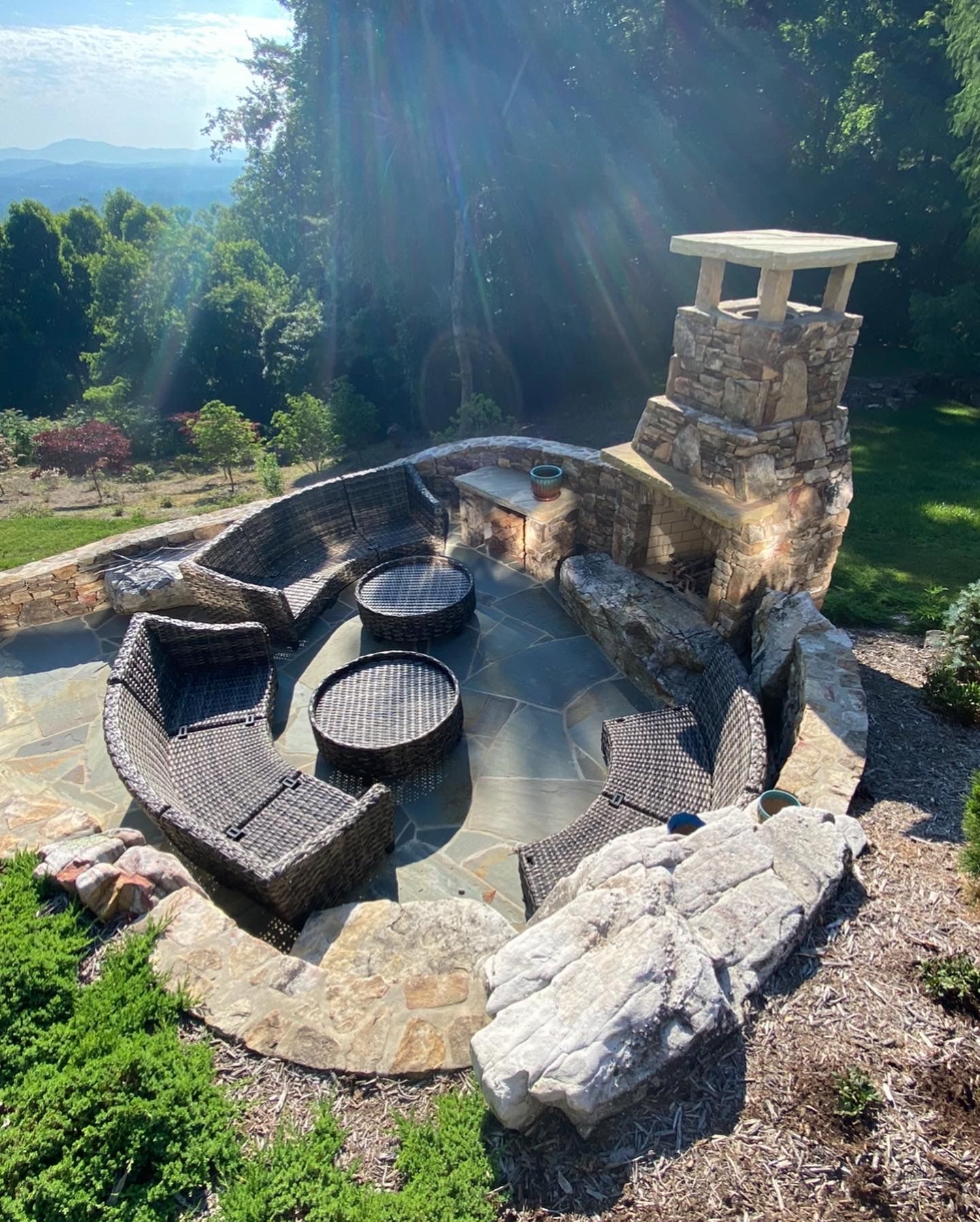 There is a fire pit in the middle of the yard with a fireplace.