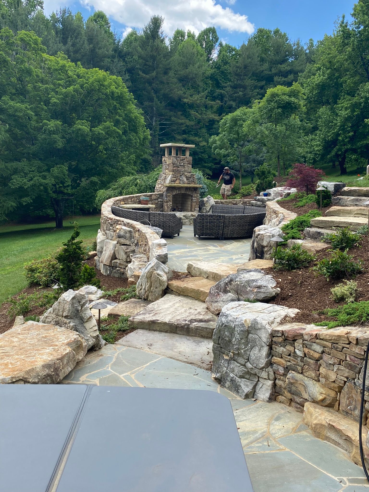 There is a fireplace in the middle of the backyard.