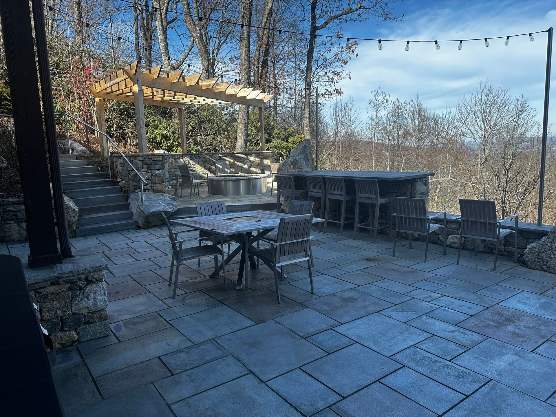 A patio with a table and chairs on it.