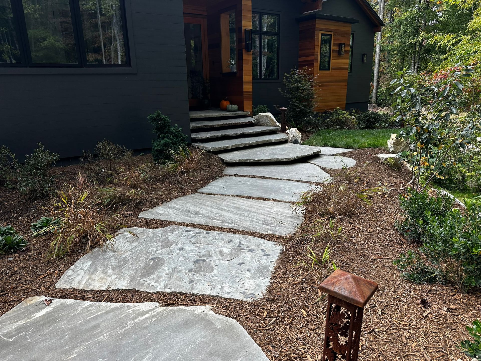 A stone walkway leading to the front door of a house.