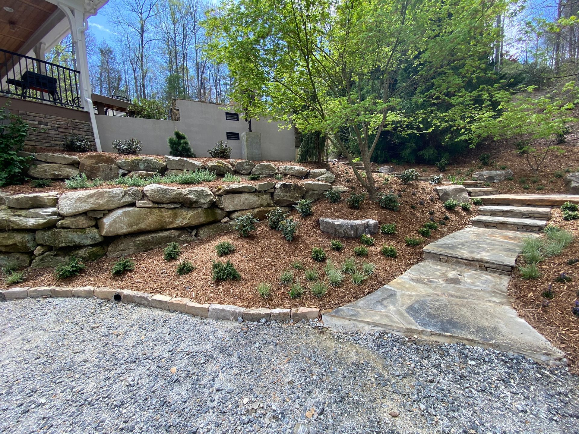A stone walkway leading up to a house on a hill.