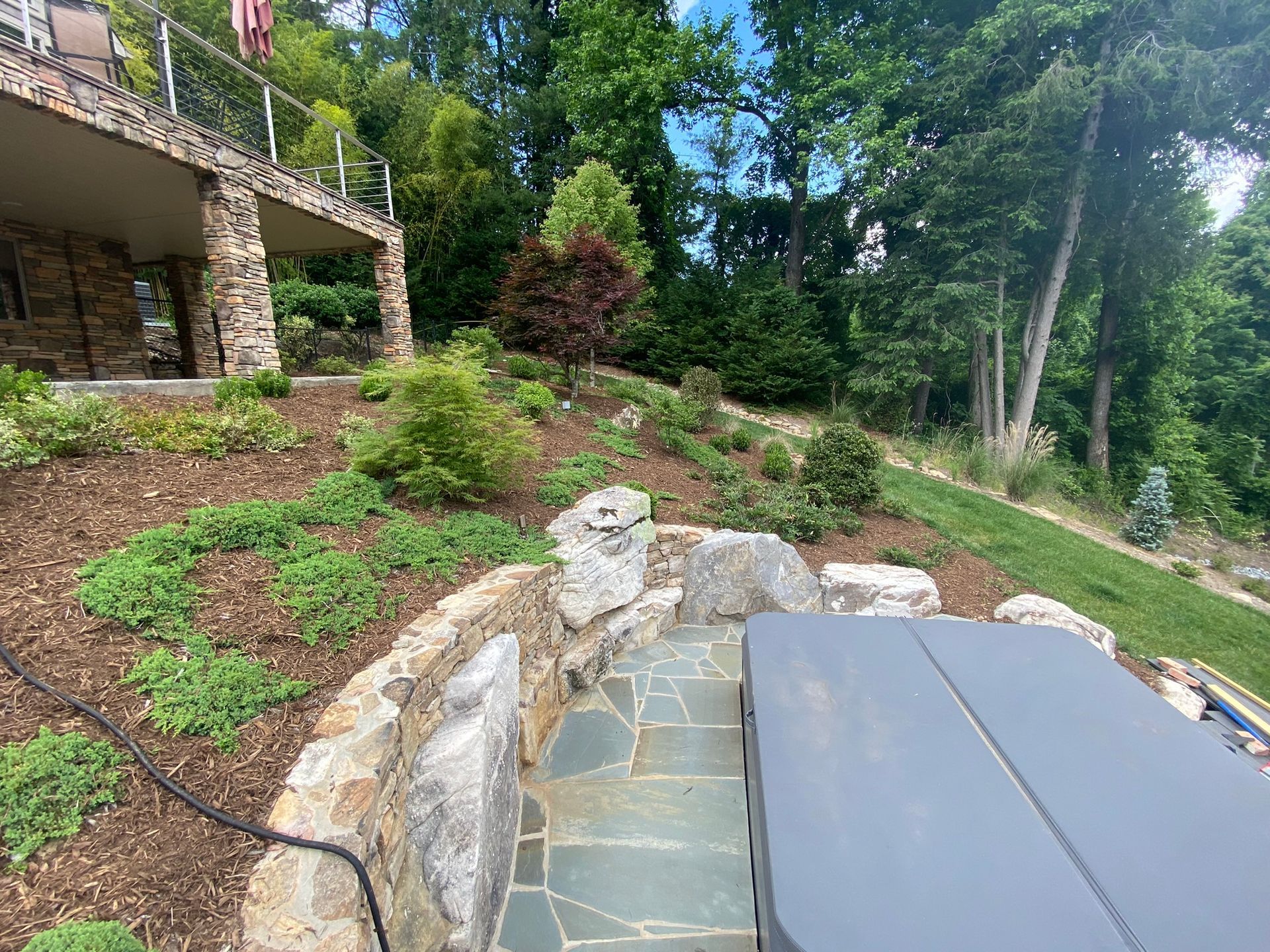 There is a hot tub in the backyard of a house.