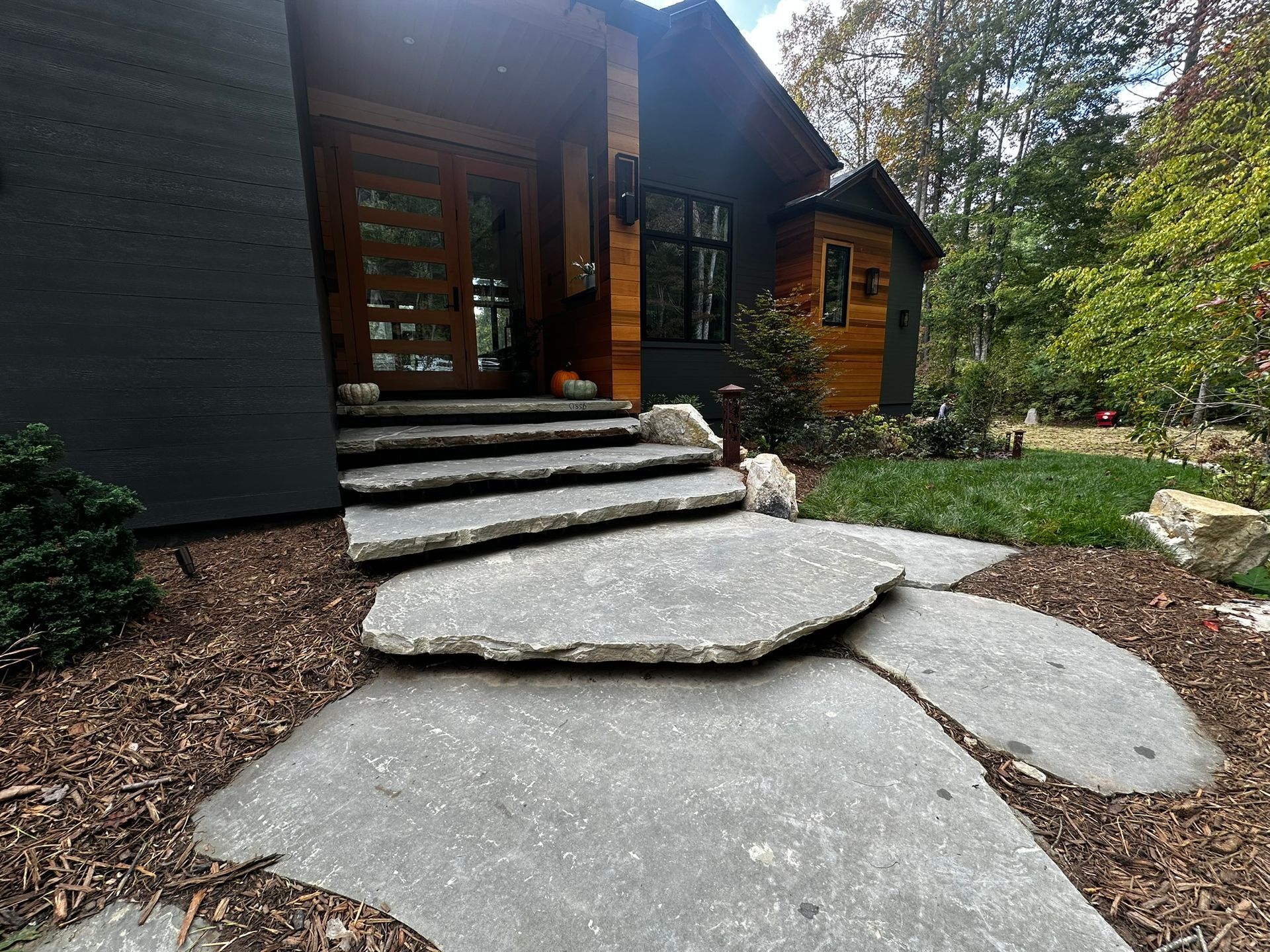 A stone walkway leading to the front door of a house.