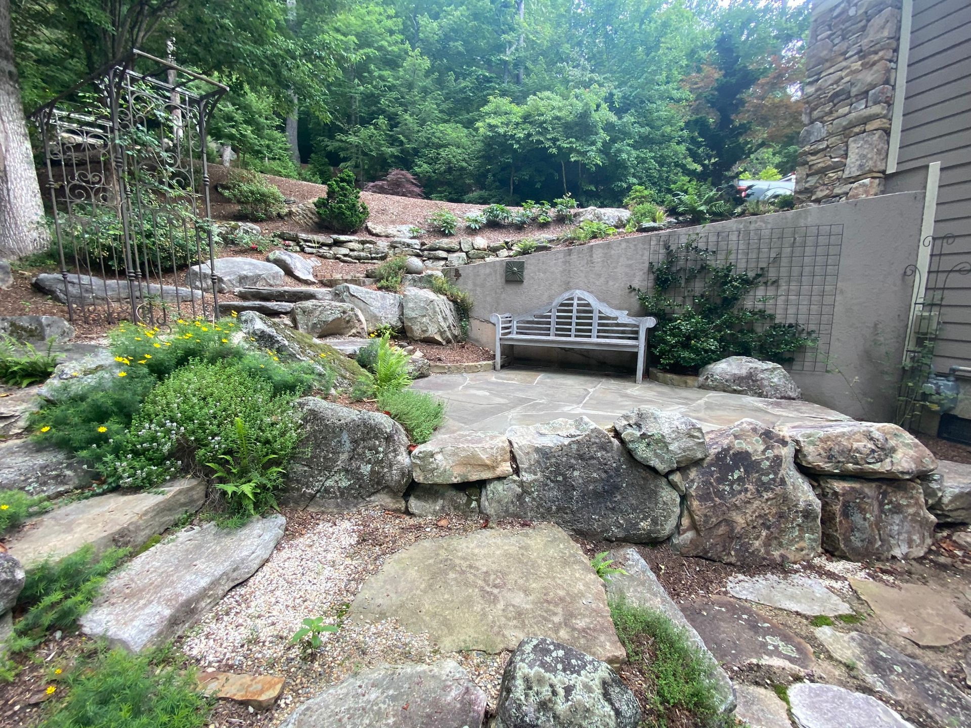 There is a bench in the middle of the rock garden.