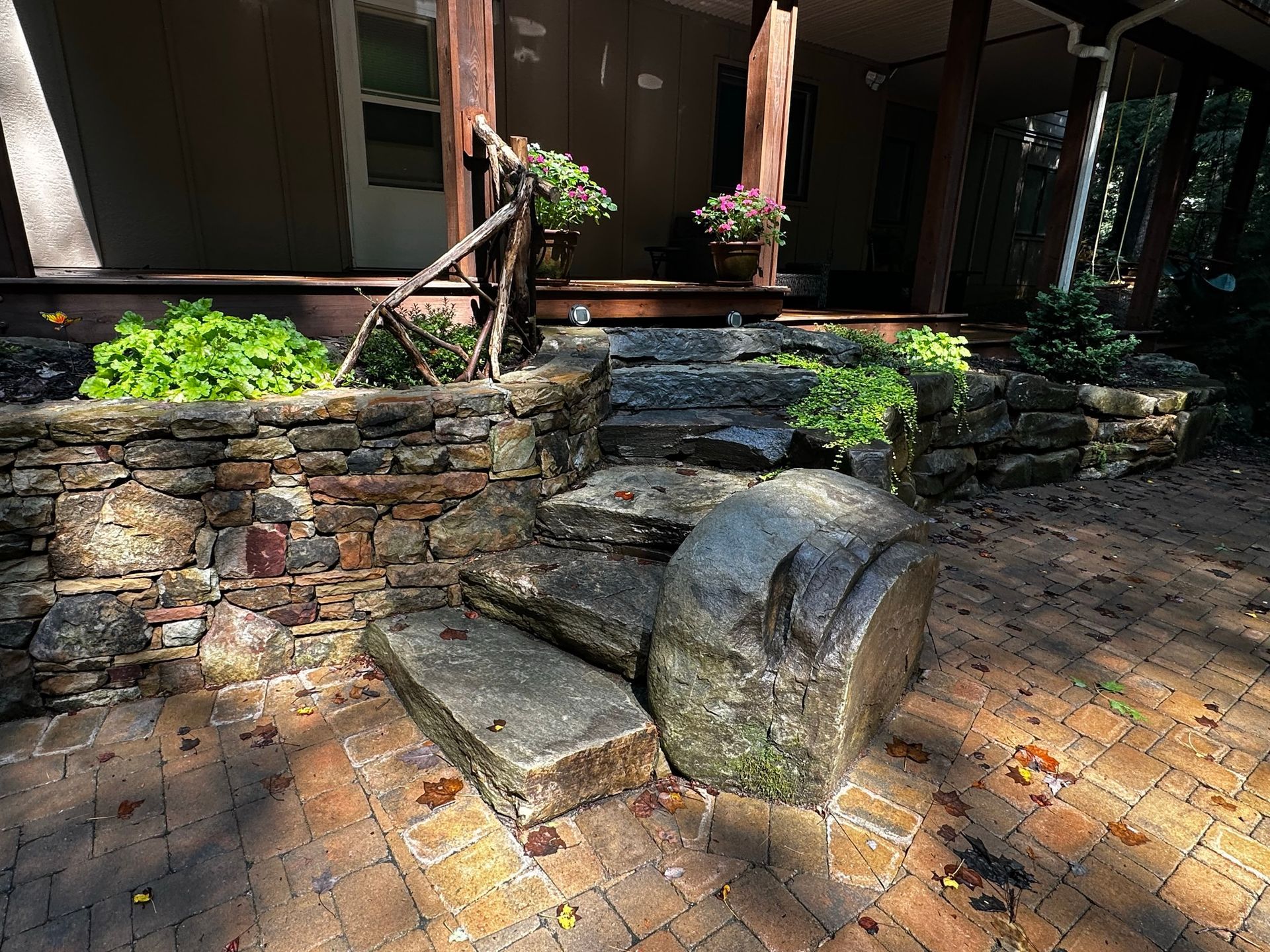 A stone staircase leading up to a porch of a house.