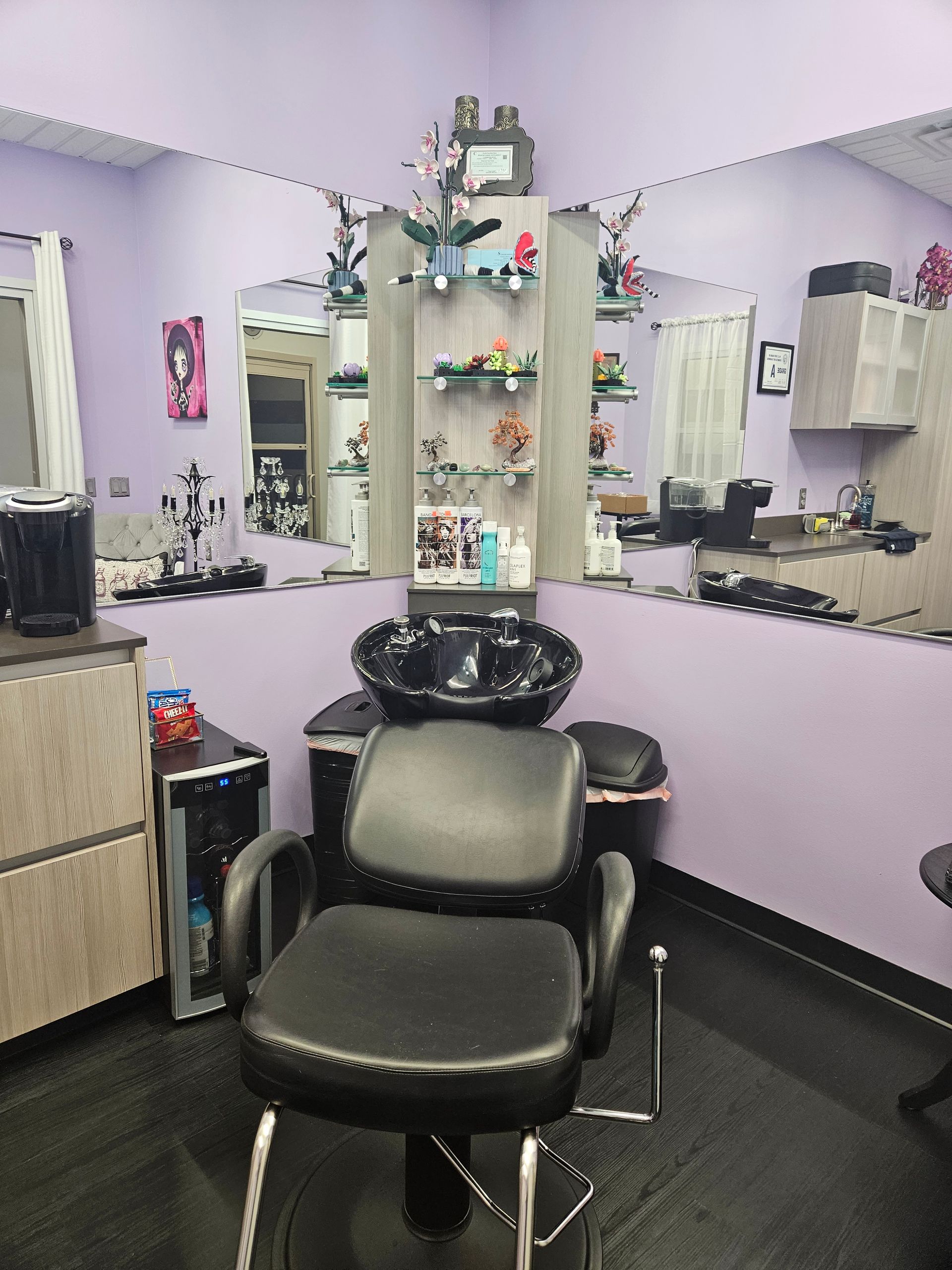 A hair salon with a chair and a sink.