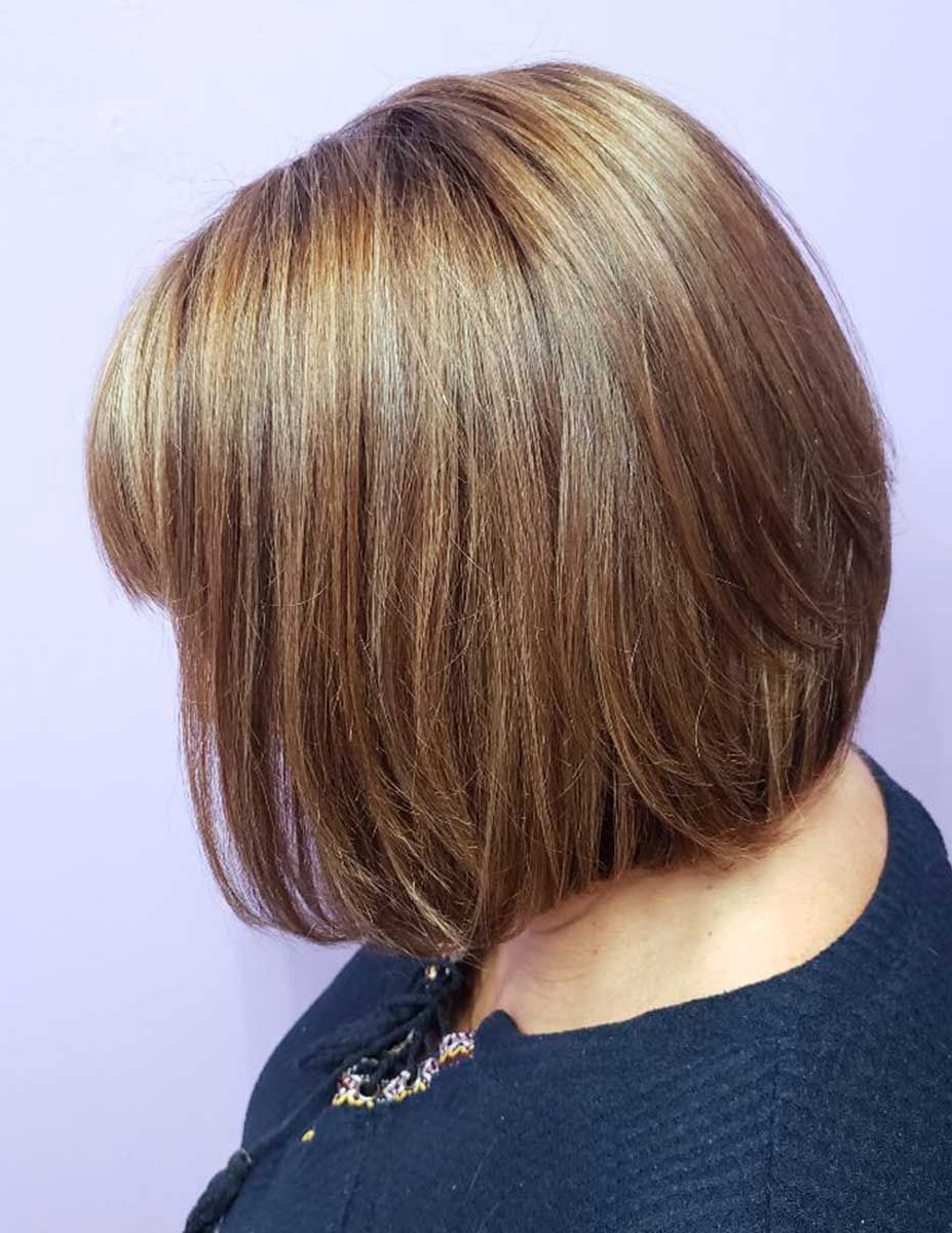 A woman with short brown hair is wearing a black jacket.