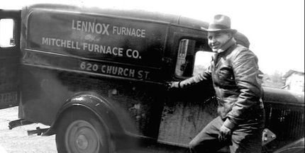 Man standing beside a vintage delivery truck labeled “Lennox Furnace” and “Mitchell Furnace Co.”