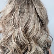 A close up of a woman 's blonde wavy hair.