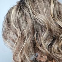 A close up of a woman 's hair with blonde highlights.