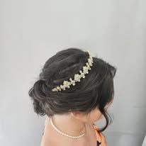 A woman is wearing a tiara in her hair.
