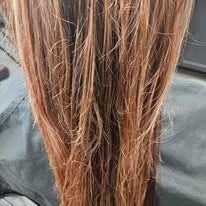 A close up of a person 's hair sitting on a table.