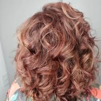 A close up of a woman 's curly hair.