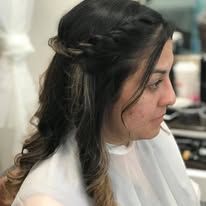 A woman is getting her hair done at a salon.
