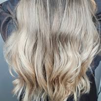 A close up of a woman 's long blonde hair.