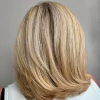 The back of a woman 's blonde hair is shown.