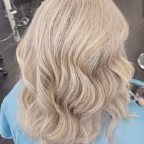 A close up of a woman 's blonde hair in a salon.