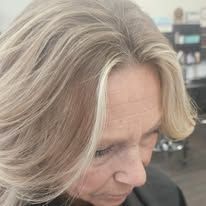 A close up of a woman 's blonde hair in a salon.