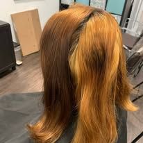 A woman is getting her hair dyed in a salon.