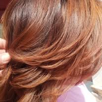A close up of a woman 's hair with a braid.