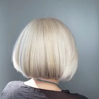 The back of a woman 's head with short blonde hair.