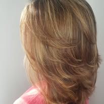 The back of a woman 's head with long blonde hair.