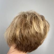 The back of a woman 's head with short blonde hair.