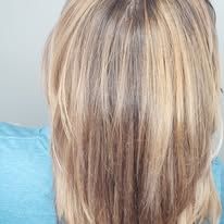 The back of a woman 's head with long blonde hair.