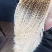 A close up of a woman 's blonde hair in a salon.
