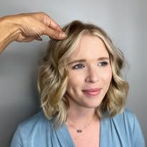 A woman is getting her hair done by a hairdresser.