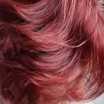A close up of a woman 's red hair.