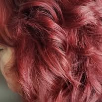 A close up of a woman 's red hair.