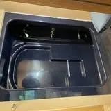 Dark-blue sink with a rectangular basin and a small, square counter extension.