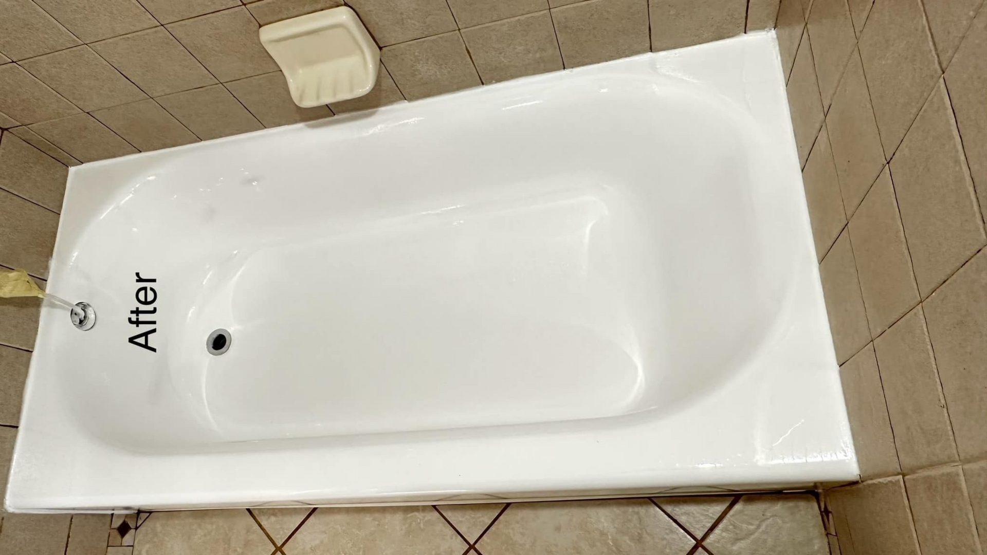 White bathtub after refinishing, in a tiled bathroom, text 