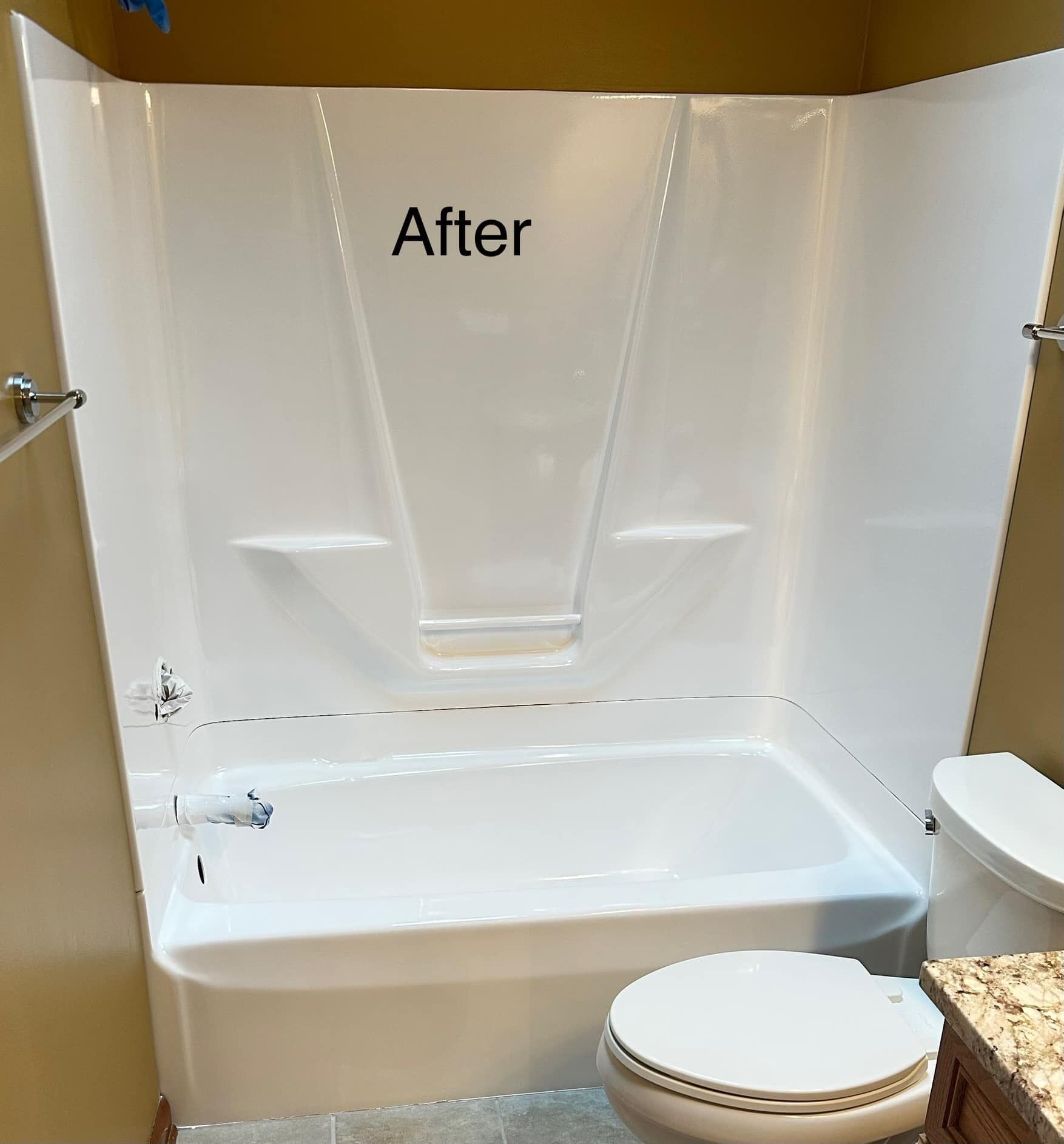 White bathroom shower and tub after remodeling with toilet.