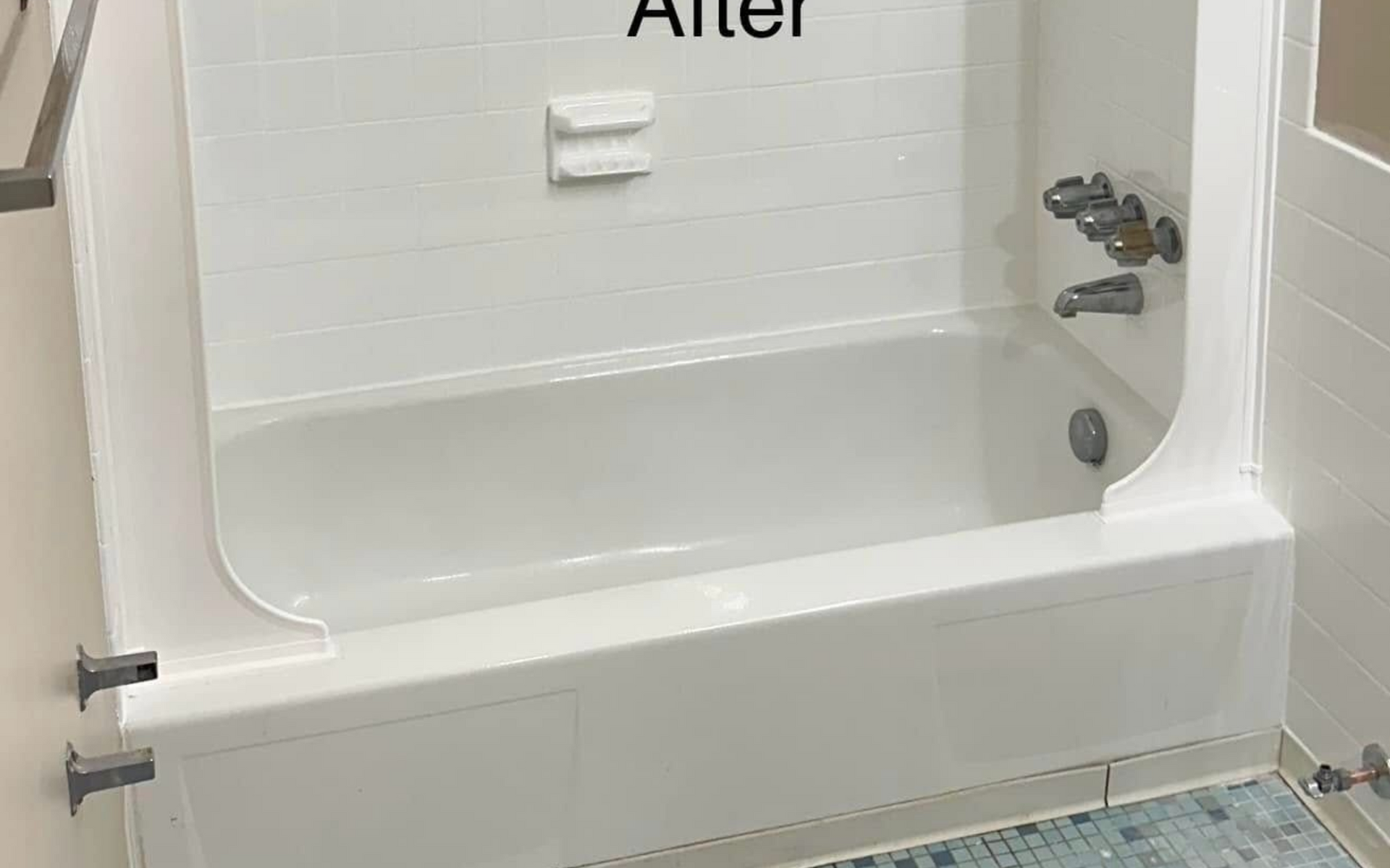 White tiled bathroom with newly renovated tub and shower area; 