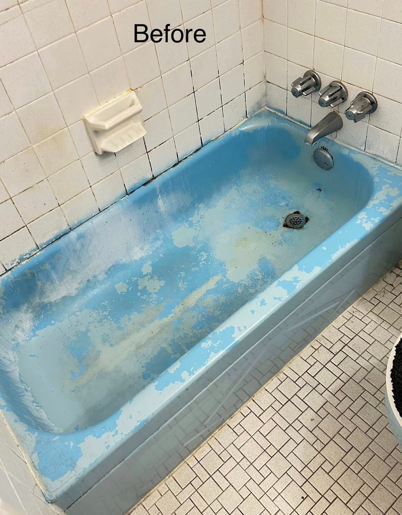 Blue bathtub with peeling paint, tile walls, and a soap dish; a 