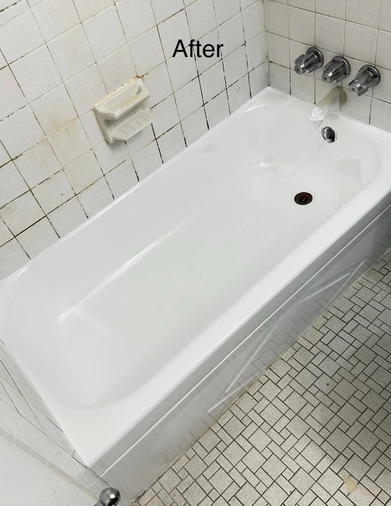 Clean white bathtub in a tiled bathroom after renovation.